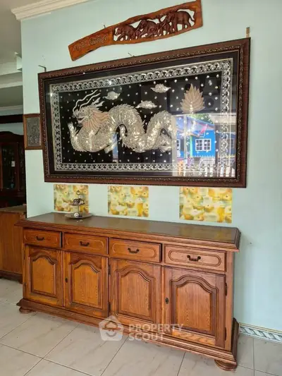 Elegant wooden sideboard with intricate dragon artwork in a stylish living room setting.