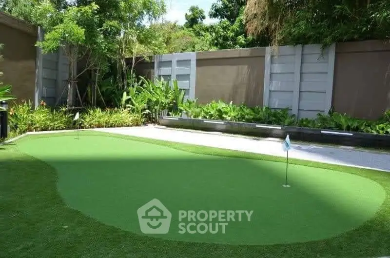 Luxurious garden with private putting green in serene residential setting.