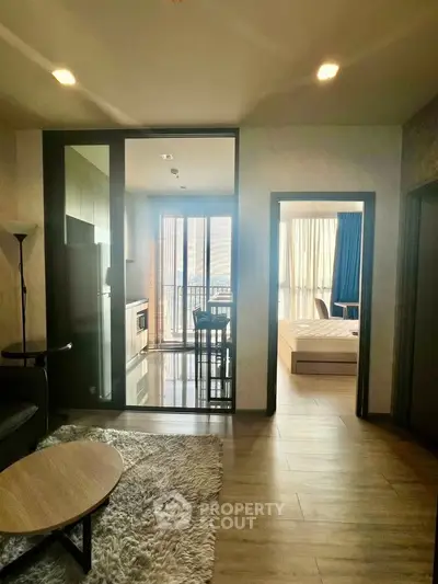 Modern apartment interior with open layout, featuring a cozy living area, sleek kitchen, and bright bedroom.