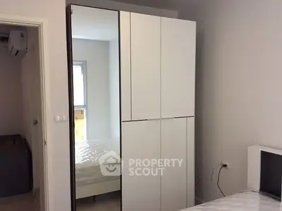 Modern bedroom with sleek wardrobe and comfortable bed in a stylish apartment.