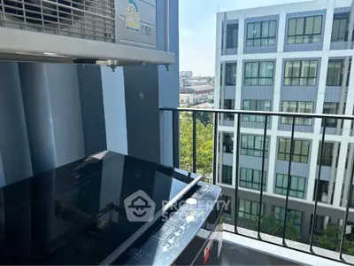 Modern apartment balcony with washing machine and city view