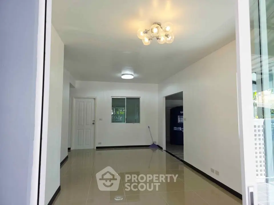 Spacious modern living room with elegant lighting and glossy tiled floors