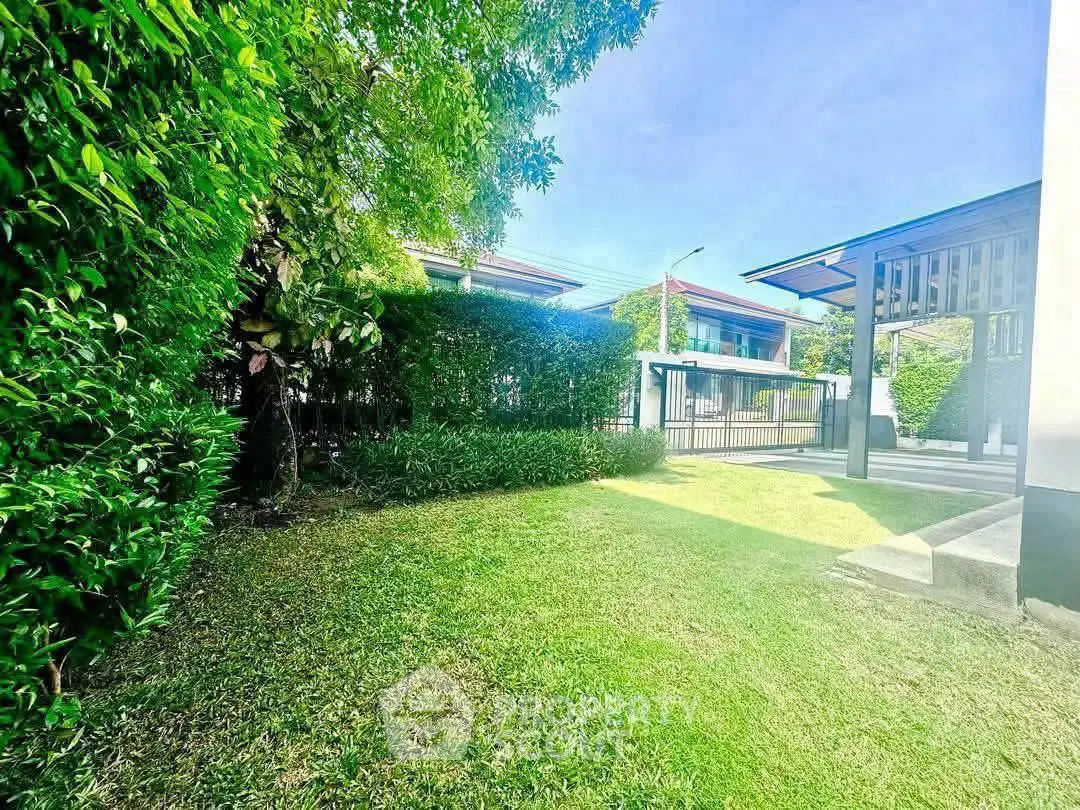 Spacious garden area with lush greenery and modern home exterior, perfect for outdoor relaxation.