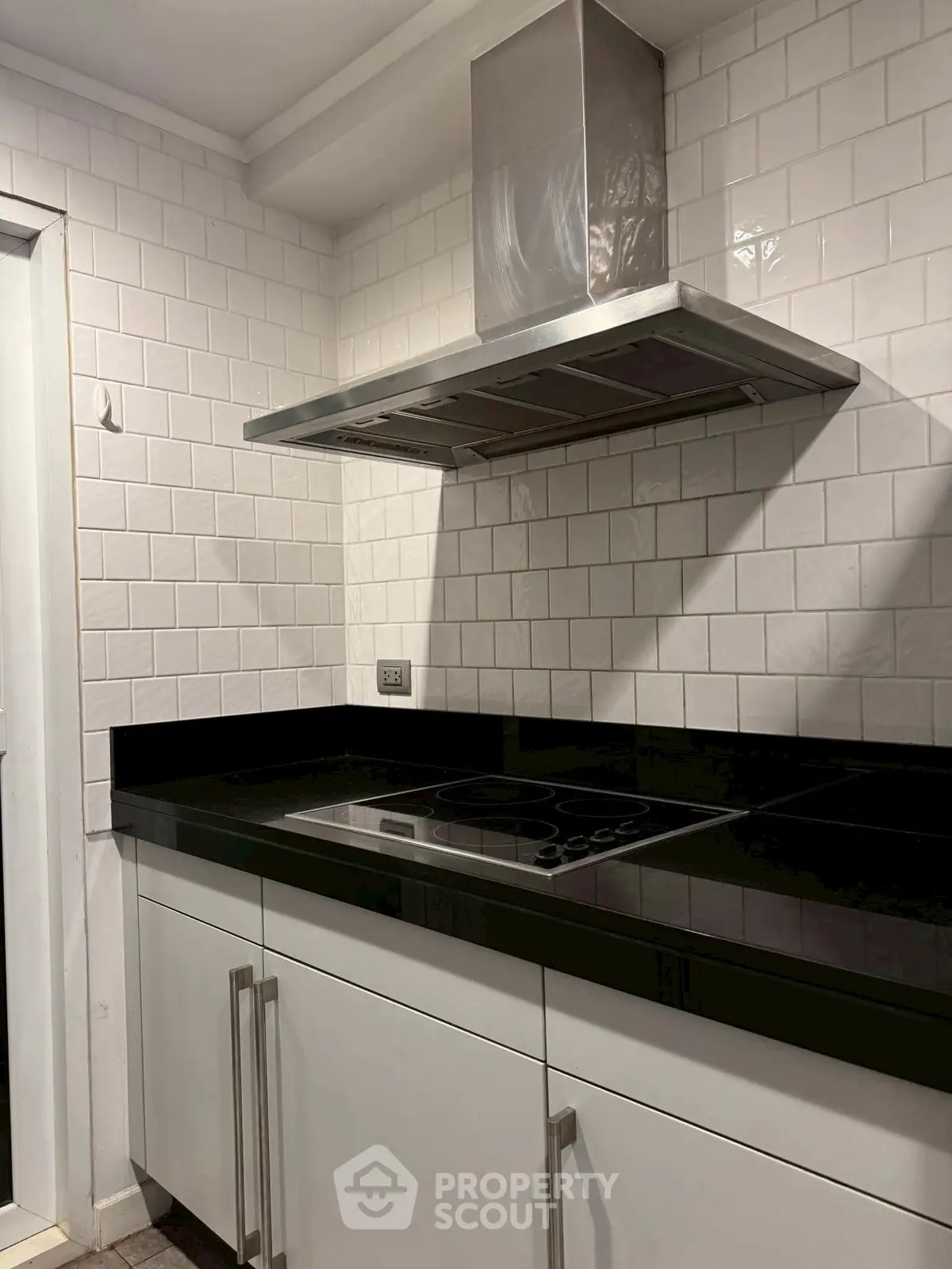 Modern kitchen with sleek black countertops and electric stove