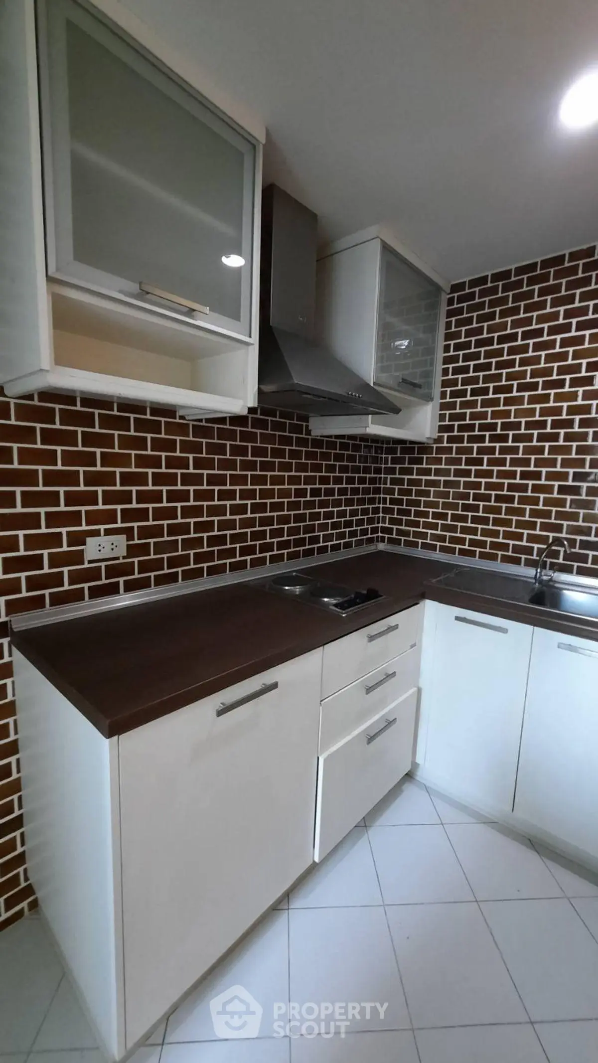 Modern kitchen with sleek cabinets and brick backsplash