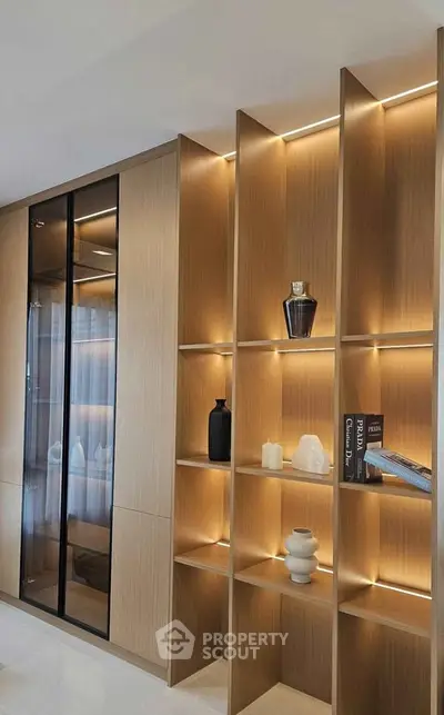 Modern living room with elegant wooden shelving and ambient lighting