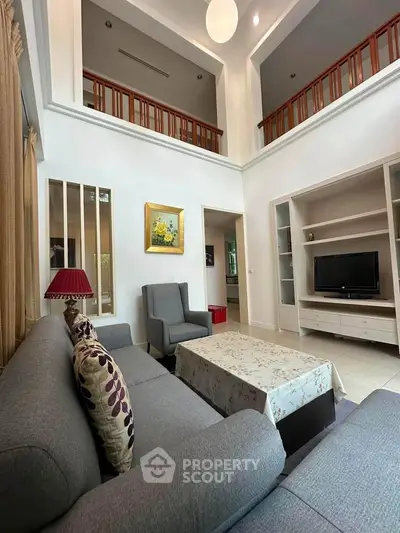 Spacious living room with high ceiling and elegant decor in modern home