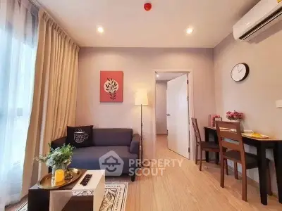 Modern living room with cozy sofa, dining area, and natural light in stylish apartment.