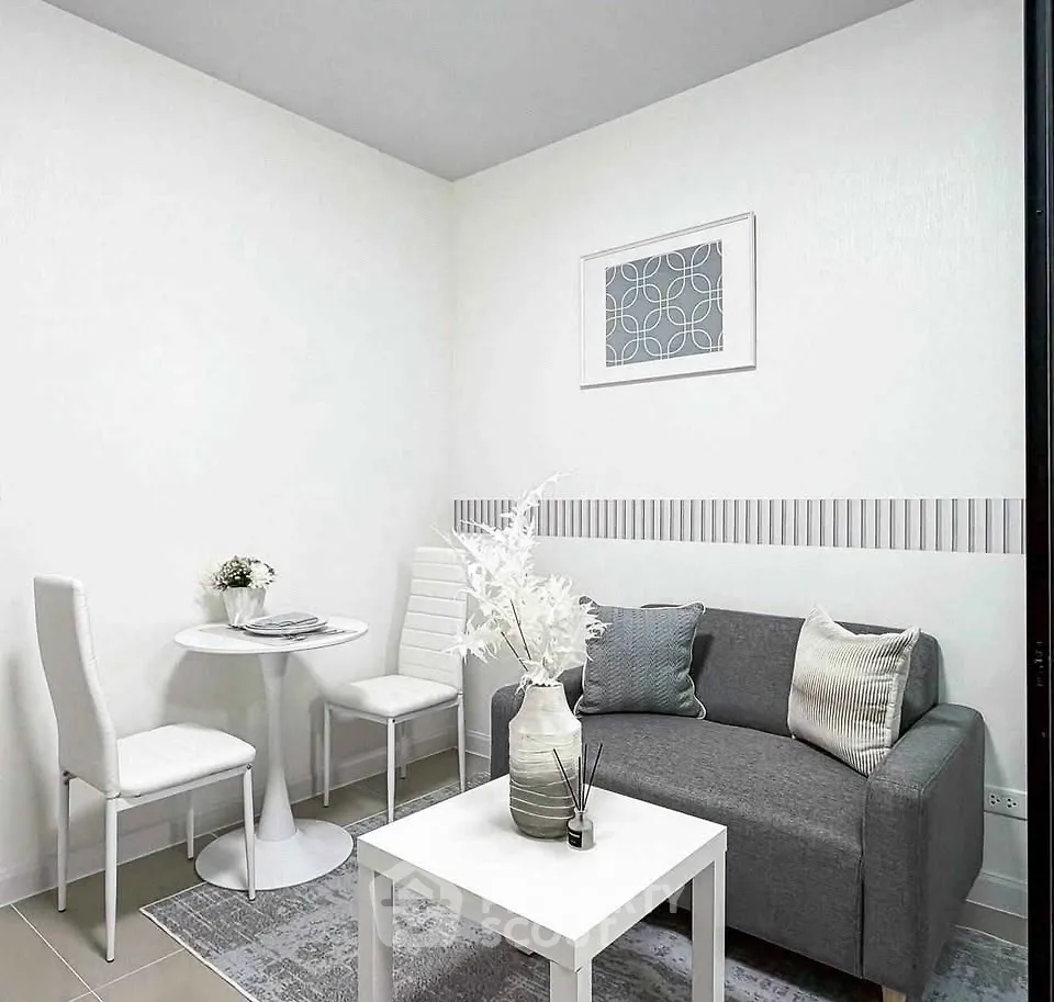 Modern minimalist living room with gray sofa and white decor
