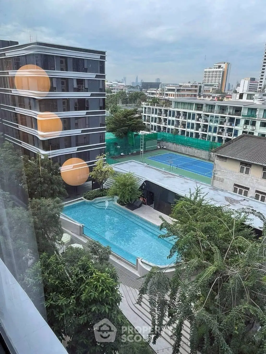 Stunning urban view with pool and tennis court, perfect for modern living.