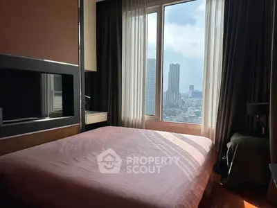 Spacious bedroom with large window offering stunning city view, perfect for urban living.