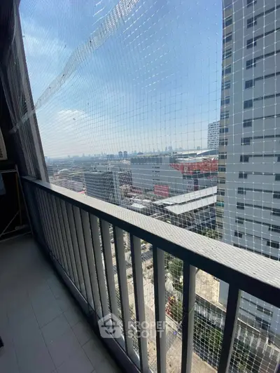 High-rise balcony with city view and safety netting, perfect for urban living.