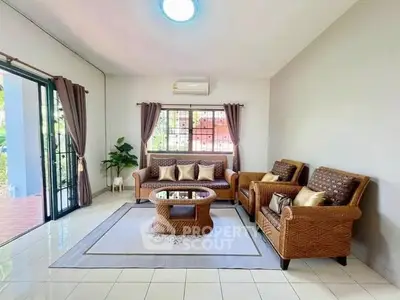 Charming living room with wicker furniture and natural light, perfect for relaxation.