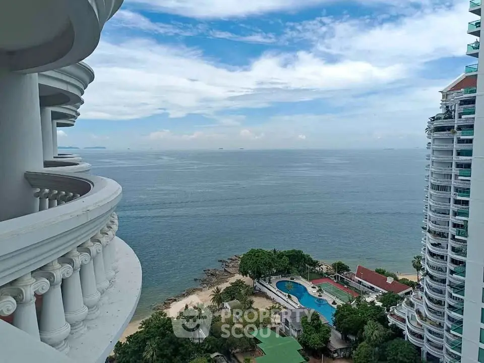 Stunning ocean view from high-rise balcony with pool and beach access