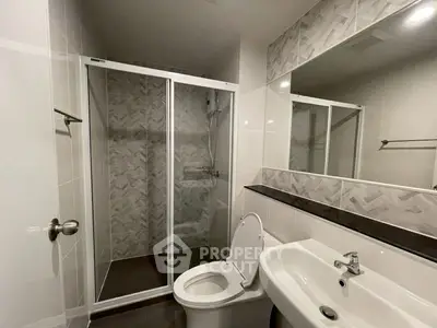 Modern bathroom with glass shower and sleek fixtures