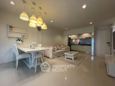 Modern open-plan living room with stylish dining area and sleek kitchen.