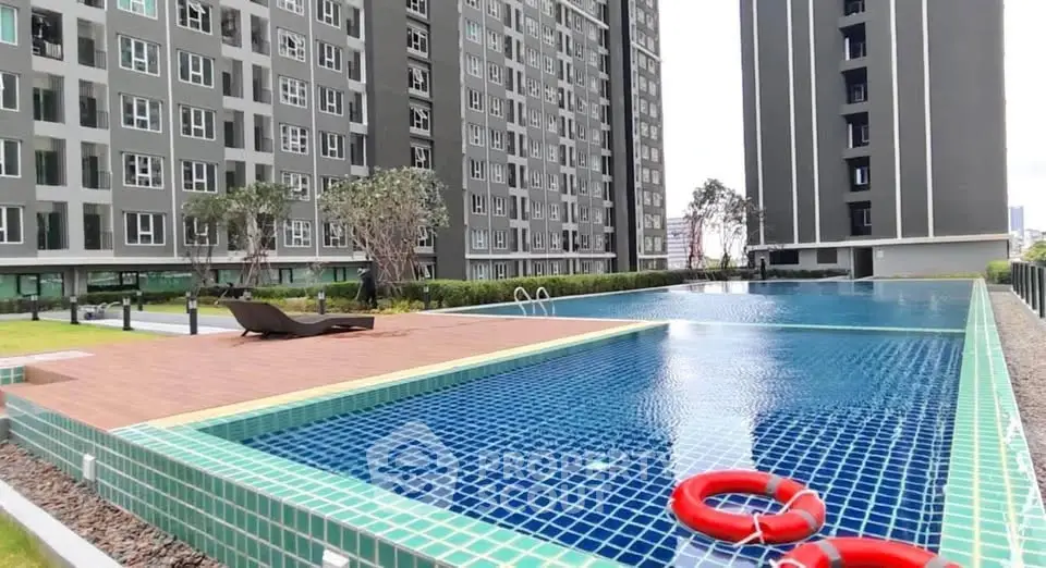 Modern condominium with luxurious swimming pool and lush garden view.