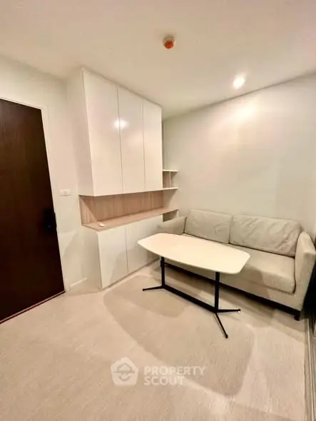 Cozy living room with modern sofa and built-in storage, perfect for urban living.