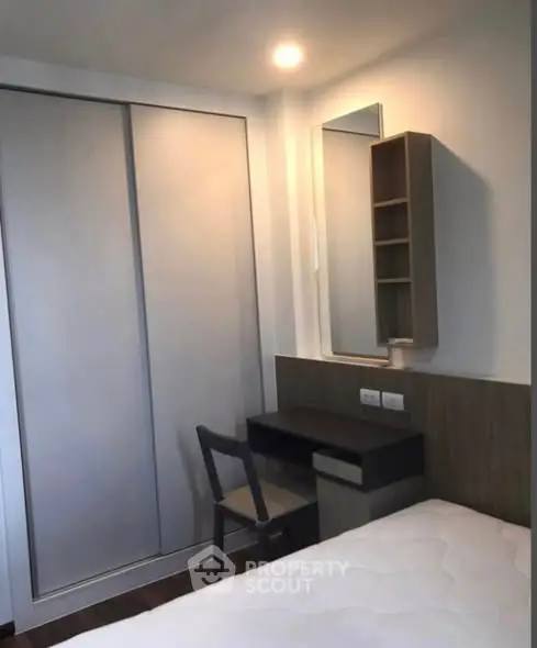 Modern bedroom with sleek wardrobe and compact study area