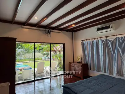 Spacious bedroom with garden view and sliding glass doors