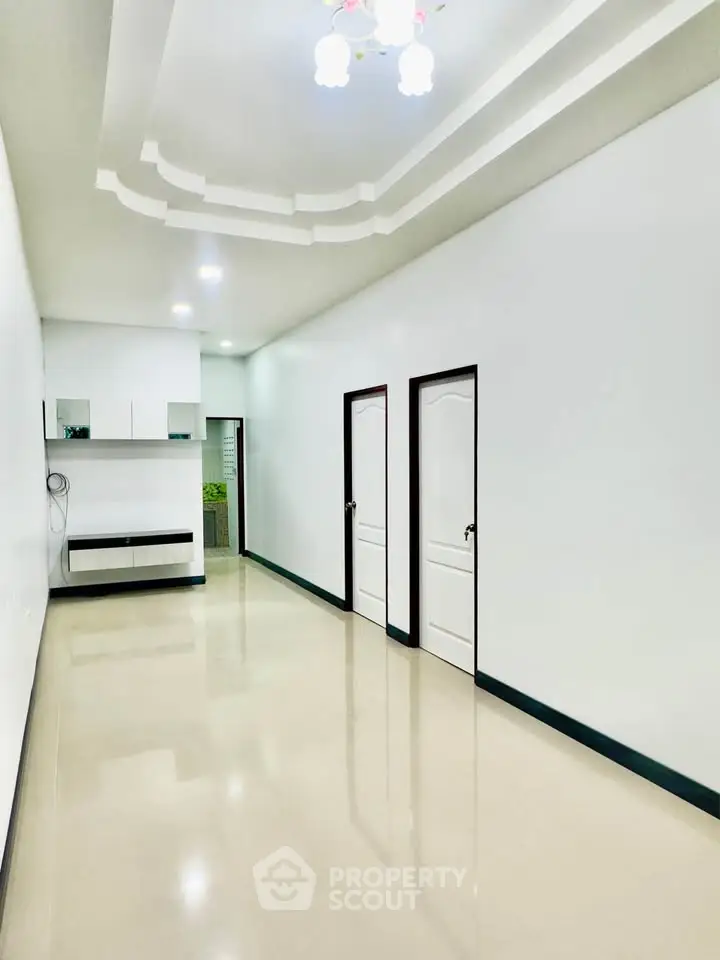 Spacious modern living room with sleek design and bright lighting