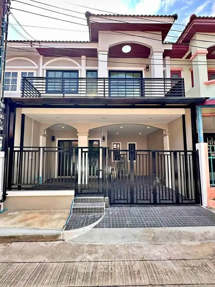 Charming townhouse with modern facade and gated entrance, perfect for urban living.