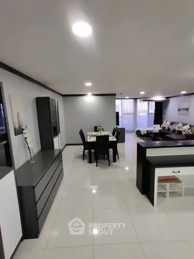 Spacious modern living room with dining area and sleek furnishings.