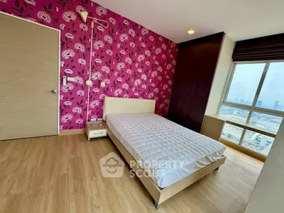 Stylish bedroom with vibrant floral wallpaper and city view window