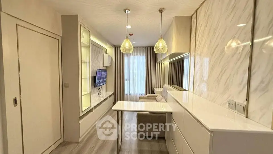 Modern living room with elegant marble walls and stylish lighting fixtures.