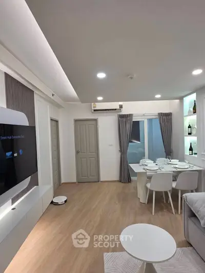 Modern living room with dining area, featuring sleek furniture and ambient lighting.