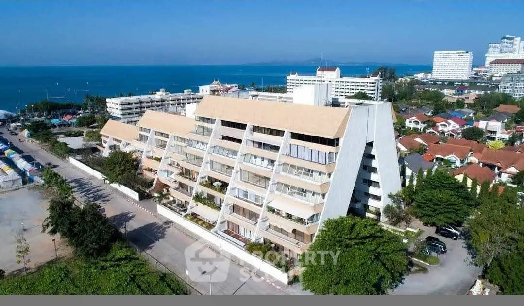 Stunning coastal apartment building with ocean views and modern architecture.