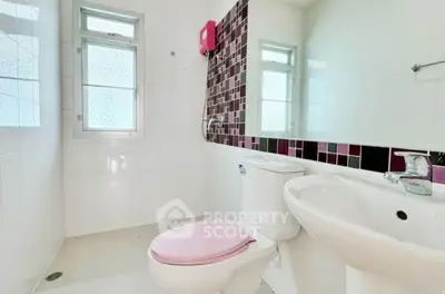 Bright and modern bathroom with stylish tile accents and natural light.