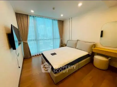 Modern bedroom with large window and stylish decor in a high-rise apartment.