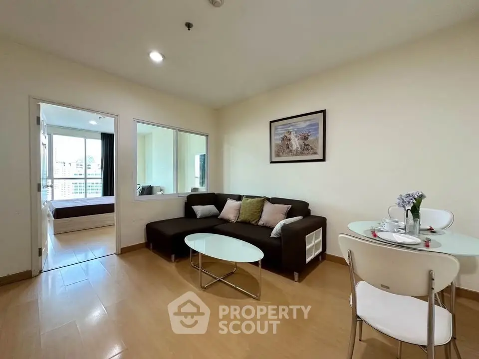 Spacious living room with modern decor and cozy seating in a bright apartment.