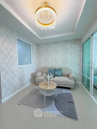 Stylish living room with elegant chandelier and cozy sofa in modern apartment