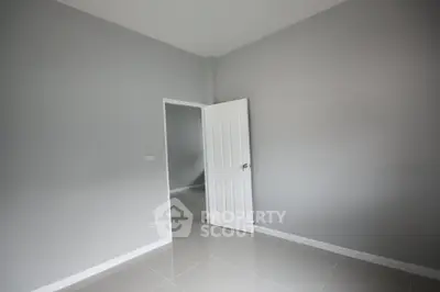 Minimalist empty room with gray walls and white door, perfect for customization.
