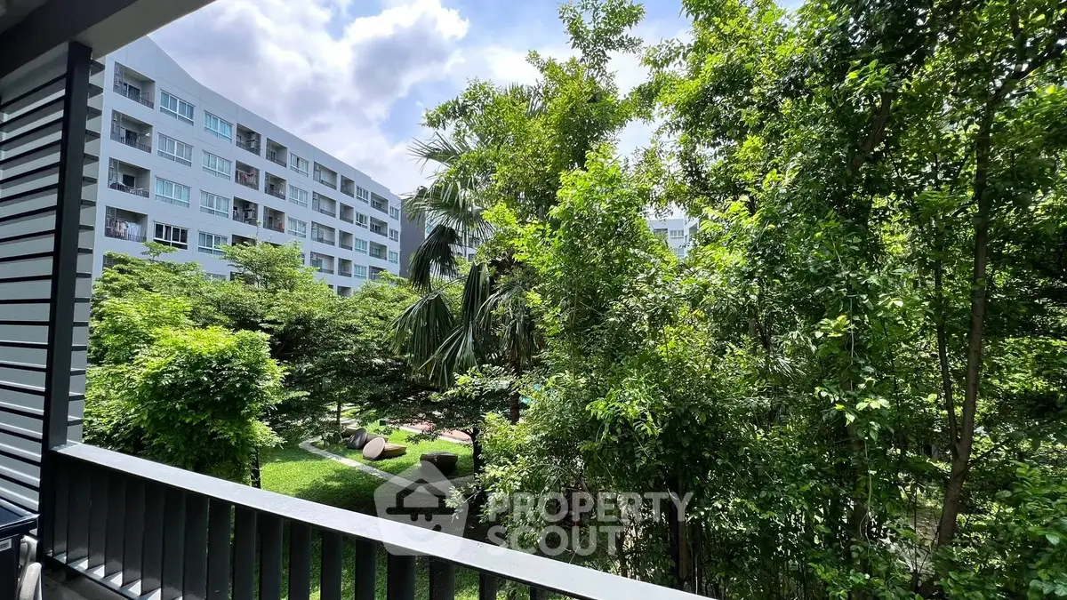 Lush garden view from a modern apartment balcony, perfect for nature lovers.