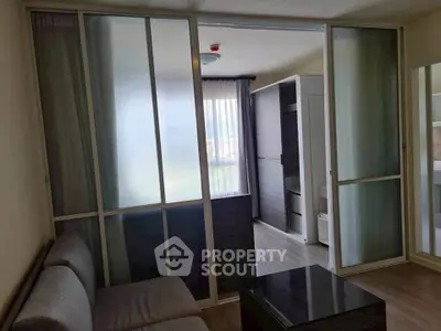 Modern living room with sliding glass doors and cozy seating area.