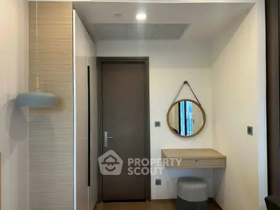 Stylish modern entryway with wooden door and round mirror