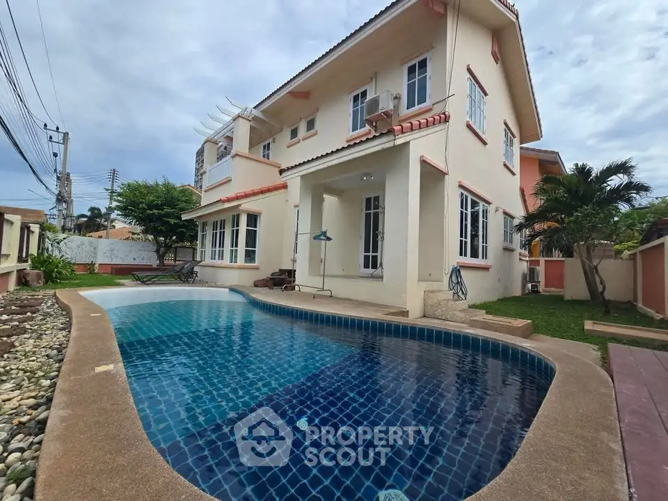 Stunning two-story house with private pool and lush garden, perfect for luxury living.