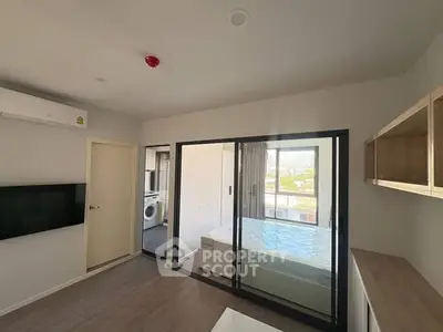 Modern apartment interior with bedroom and living area, featuring large windows and sleek design.