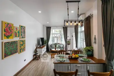 Charming living room with elegant decor and natural light, featuring a cozy seating area and stylish dining space.