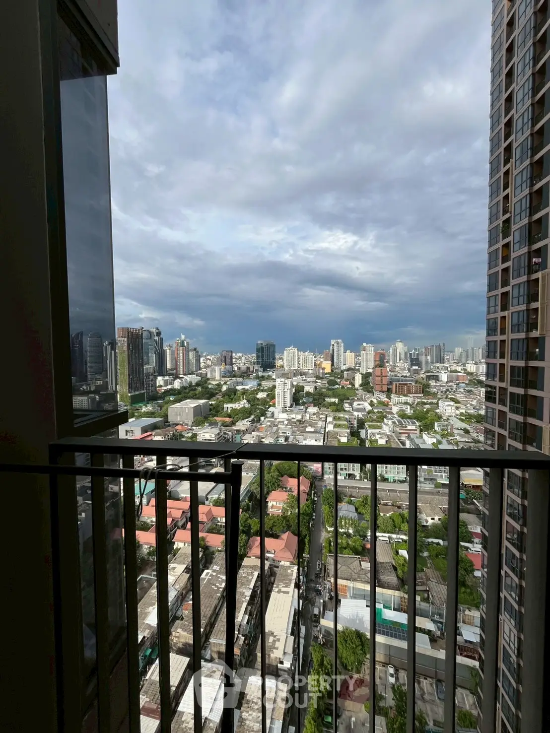Stunning cityscape view from high-rise balcony with expansive skyline and urban landscape.