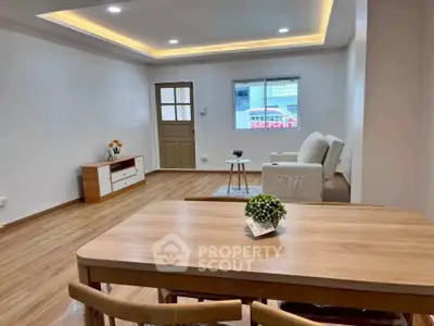 Spacious living room with modern decor and wooden flooring, perfect for relaxation and entertaining.