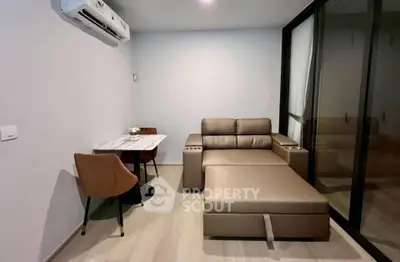 Modern living room with sleek furniture and air conditioning in a stylish apartment.