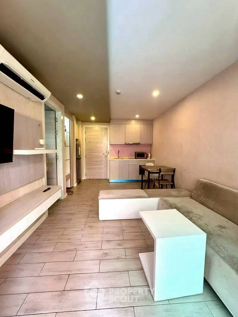 Modern living room with open kitchen layout and stylish furniture