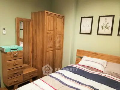 Cozy bedroom with wooden furniture and striped bedding