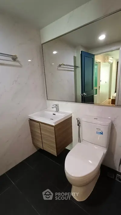 Modern bathroom with sleek fixtures and elegant marble walls.