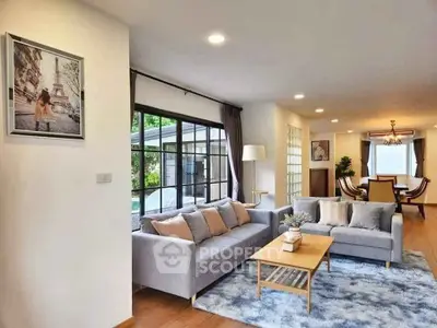 Spacious living room with modern decor and large windows for natural light.