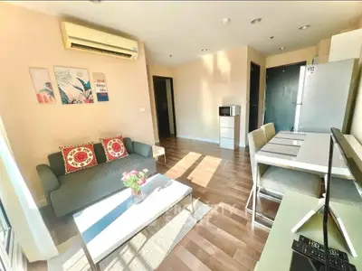 Bright and modern living room with stylish decor and open layout, featuring a cozy sofa and dining area.